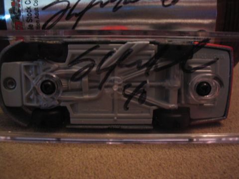 1998 Ford Crown Victoria - The underside of a toy car, signatures and the number 54, is displayed.