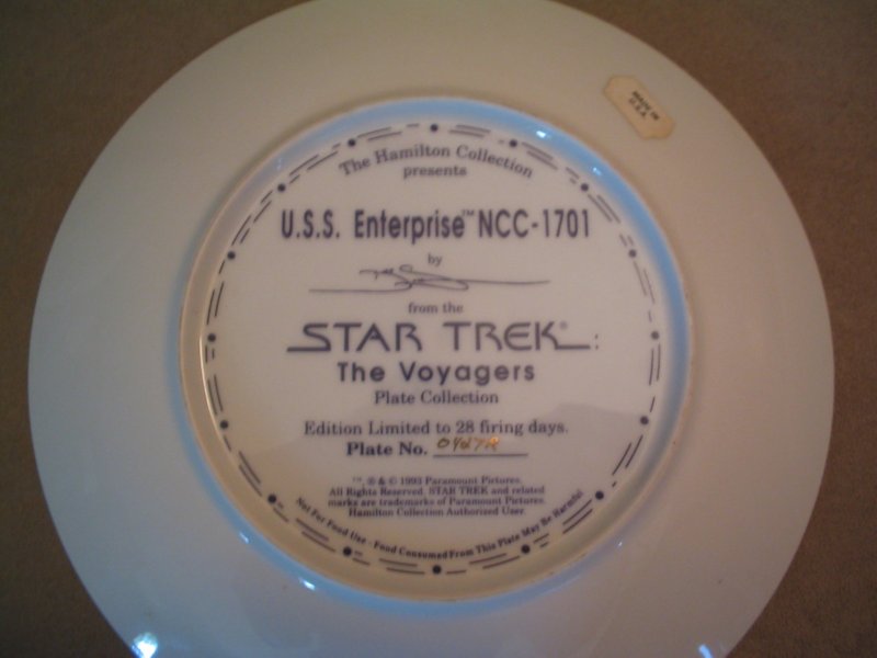 White decorative plate with Star Trek graphics and text