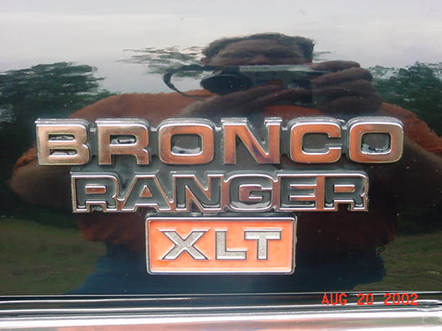Chrome 'BRONCO RANGER XLT' emblem on a dark glossy body panel
