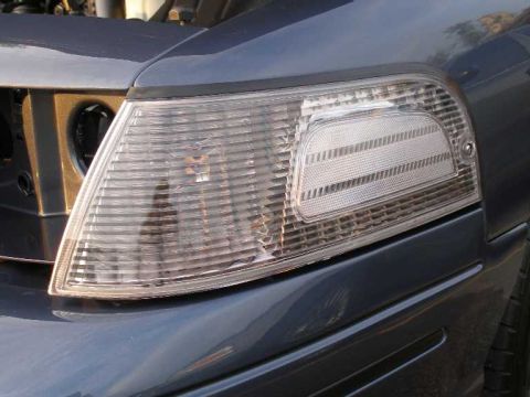 1998 Ford Crown Victoria - Close-up of the front passenger side headlight and corner lamp assembly on a 1998 Ford Crown Victoria.