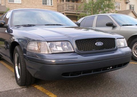 1998 Ford Crown Victoria - Front view of a 1998 Ford Crown Victoria with a black honeycomb grille and clear corner lamps.