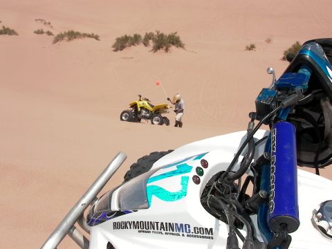 2003 Suzuki LTZ400 - Two quad bikes are seen in the sand dunes, one with a person holding a flag.