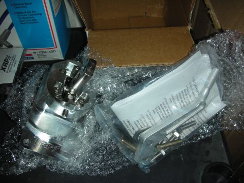 1998 Ford Crown Victoria - A silver shifter mechanism is shown with its installation instructions and hardware, packaged in bubble wrap.