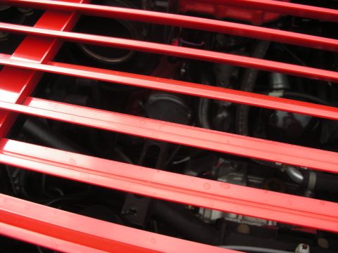 1998 Ford Crown Victoria - The red grille obscures most of the engine bay details in this close-up shot.