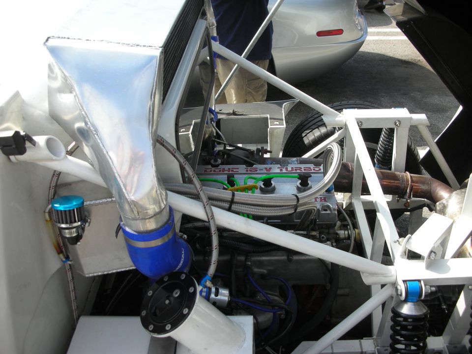 Engine bay with DOHC 16-V TURBO engine, custom intake piping, and suspension components