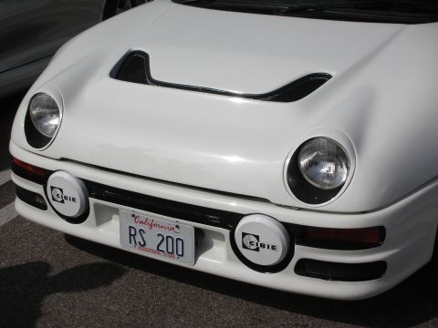 1998 Ford Crown Victoria - The front of a white Ford RS200 is shown, its distinctive hood scoop and Cibie fog lights.