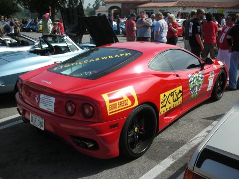1998 Ford Crown Victoria - Red Ferrari 360 Modena at a car meet, displaying various sponsor decals and a license plate reading 'B F 360'.
