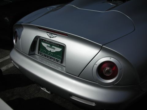 1998 Ford Crown Victoria - Rear view of a silver Aston Martin with a green license plate.