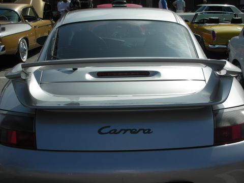 1998 Ford Crown Victoria - Rear view of a silver Porsche 911 Carrera, showing its distinctive spoiler and badging.