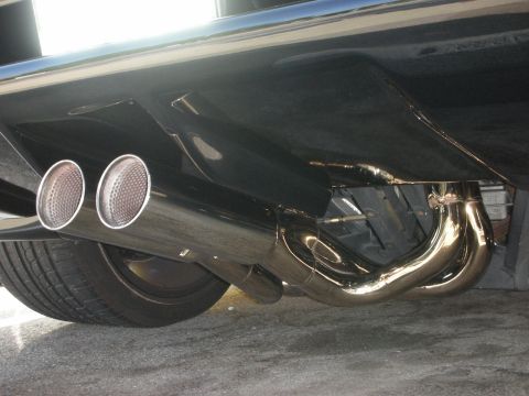 1998 Ford Crown Victoria - Close-up of a custom dual exhaust system on a vehicle's underside.