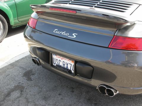 1998 Ford Crown Victoria - A dark gray Porsche 911 Turbo S is parked next to a green car.
