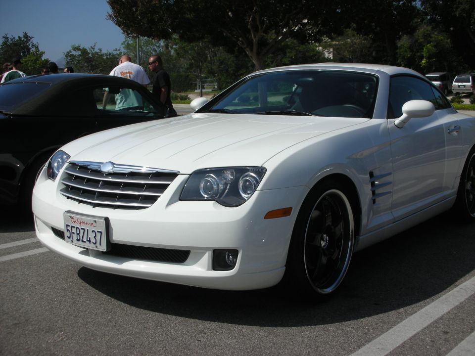 White Chrysler Crossfire coupe parked, California license plate 5FBZ437 visible. Black convertible in background