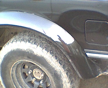 1989 Ford Bronco - Close-up of the rear wheel well and tire on a 1989 Ford Bronco.