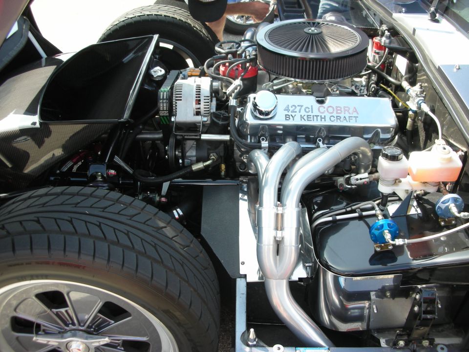 Engine bay with "427ci COBRA BY KEITH CRAFT" valve cover, chrome headers, and air filter