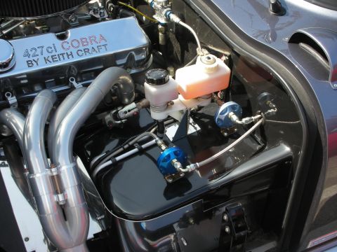 1998 Ford Crown Victoria - Close-up of a "427ci COBRA BY KEITH CRAFT" engine, chrome valve covers and custom exhaust headers.