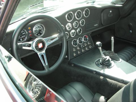 1998 Ford Crown Victoria - The dashboard of a classic car features a variety of gauges and a three-spoke steering wheel.