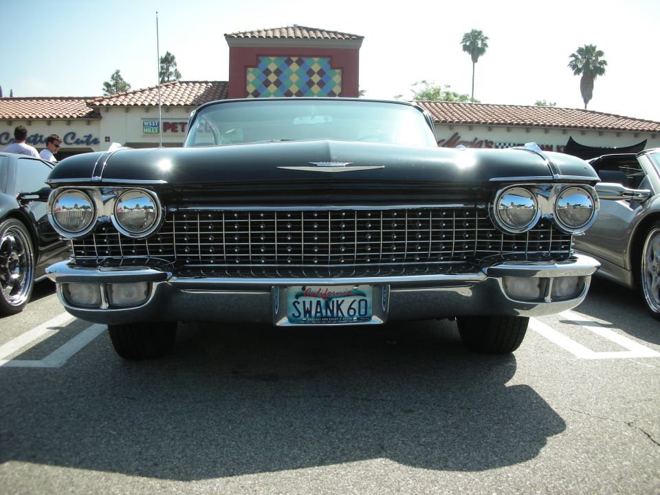 Front view of black 1960 Cadillac convertible with California plate SWANK 60