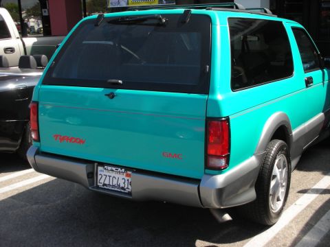 1998 Ford Crown Victoria - Rear view of a teal GMC Typhoon with a California license plate.