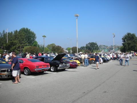 1998 Ford Crown Victoria - A variety of classic cars are on display at an outdoor gathering on a sunny day.