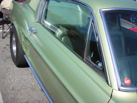 1998 Ford Crown Victoria - A light green classic car is viewed from the side, with a drag slick tire and louvers visible on the rear quarter panel.