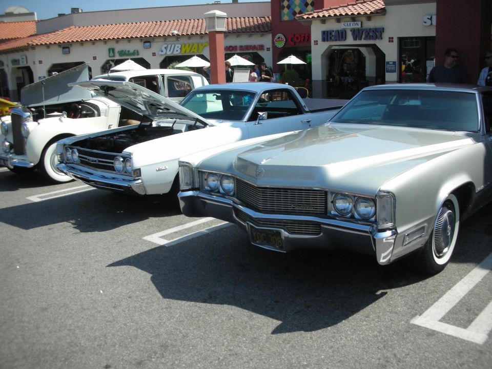 Silver Cadillac front view with chrome grille and dual headlights
