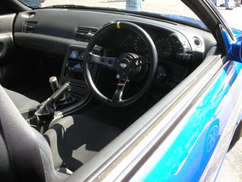 1998 Ford Crown Victoria - Interior view of a blue car, an aftermarket Momo steering wheel and a manual transmission shifter.