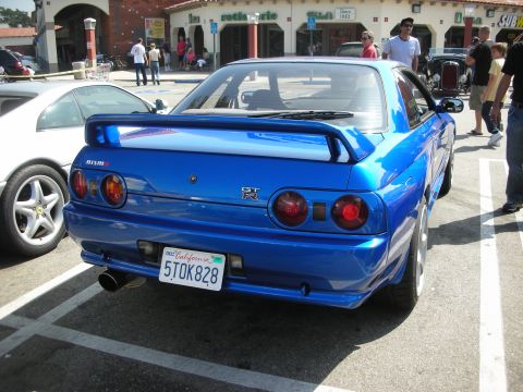 1998 Ford Crown Victoria - Rear view of a blue Nissan Skyline GT-R R32 parked next to a white car at a meet.