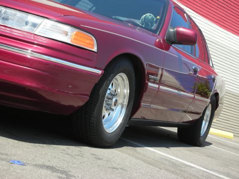 1992 Ford Crown Victoria - 1992 Ford Crown Victoria in maroon with aftermarket chrome wheels and polished side trim.