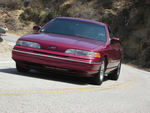 1992 Ford Crown Victoria - Maroon 1992 Ford Crown Victoria captured from the front on a scenic drive.