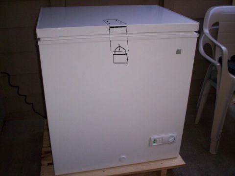 1989 Ford Bronco - A white chest freezer is shown from the front, with a diagram drawn on its lid and a chair visible to the side.