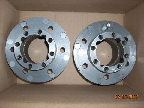 2000 Chevrolet Tahoe - Two metal hub adapter parts are shown inside a cardboard box.