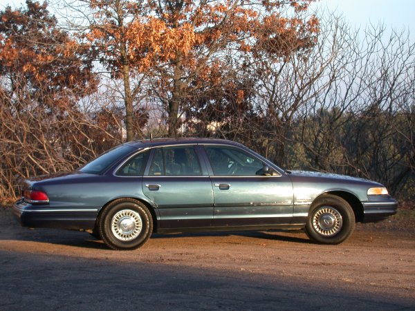 Blue 1995 Ford Crown Victoria sedan, side view