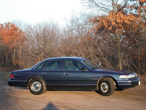 1995 Ford Crown Victoria - Side view of a 1995 Ford Crown Victoria parked outdoors.