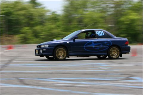 2001 Mercury Grand Marquis - A blue Subaru Impreza WRX STI competes in an autocross event, displaying its racing number 401.