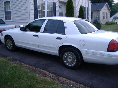 2003 Ford Crown Victoria - This white 2003 Ford Crown Victoria is shown from a 3/4 front angle.