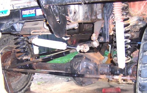 1978 Ford Bronco - Close-up view of the undercarriage, highlighting suspension and steering components, and a Reese hitch label.