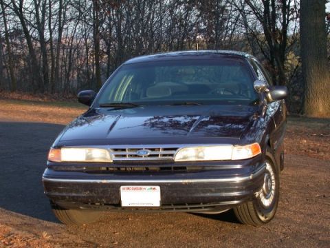 1995 Ford Crown Victoria - This 1995 Ford Crown Victoria is seen from the front in an outdoor setting with trees in the background.