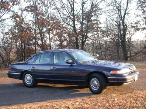1995 Ford Crown Victoria - Side view of a 1995 Ford Crown Victoria sedan parked outdoors on a paved surface.