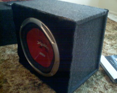 1901 Honda Odyssey - A black subwoofer with a red cone is shown on a carpeted surface.