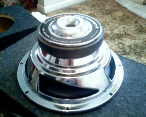 1901 Honda Odyssey - Car subwoofer with chrome basket and black cone, labeled '700 WATTS POWER HANDLING'.