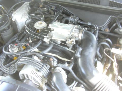 1996 Ford Crown Victoria - Close-up view of a car's engine bay, showing mechanical components and wiring.
