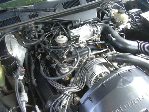1996 Ford Crown Victoria - Close-up view of a vehicle's engine bay, showing various components and wiring.
