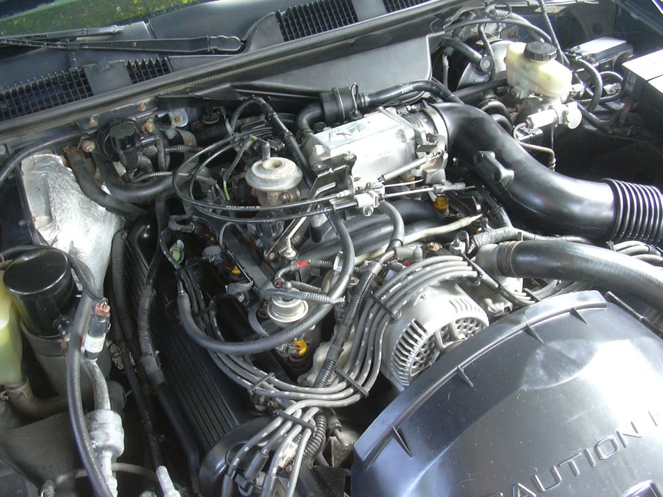 Engine bay with visible alternator and intake manifold