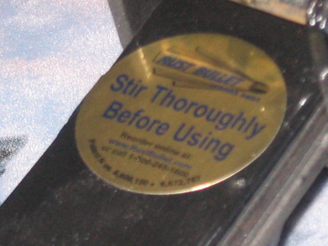 Rust Bullet label with instructions to stir thoroughly before using, and website/phone number for reordering