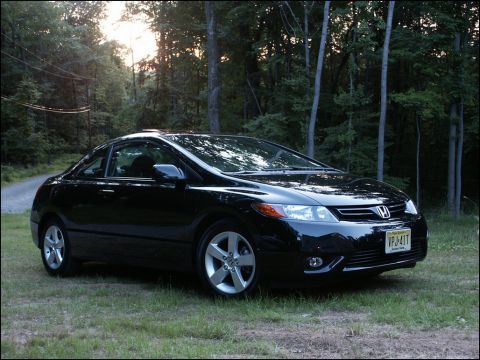 2001 Mercury Grand Marquis - Black Honda Civic coupe parked on grass with trees in background. License plate VPJ-41T.
