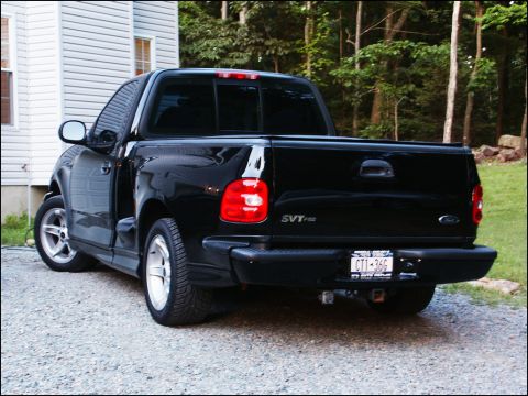 2001 Mercury Grand Marquis - This black Ford SVT F-150 Lightning pickup truck is viewed from the rear 3/4 angle.
