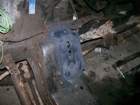 1982 Ford Bronco - Close-up view of vehicle undercarriage components, showing rust and wiring.