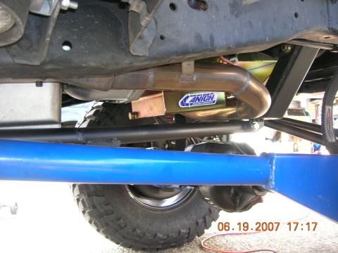 1996 Ford Bronco - Close-up view of a vehicle's undercarriage, highlighting custom suspension and exhaust components.