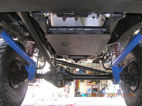 1996 Ford Bronco - The underside of a vehicle is shown, revealing its suspension and drivetrain components.