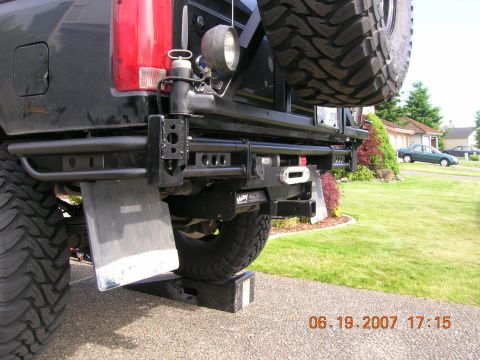 1996 Ford Bronco - The rear of a modified truck is shown, a heavy-duty bumper and a spare tire carrier.